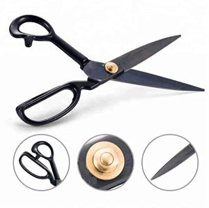 Black scissors with gold accents on a white background, showing close-up details.