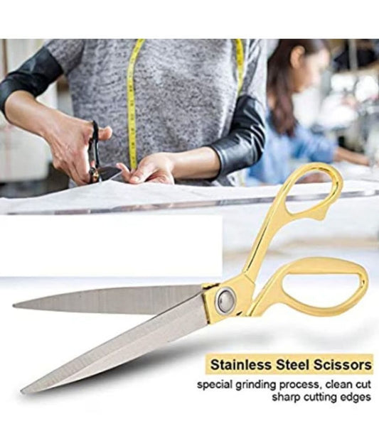Gold scissors with text on a white background