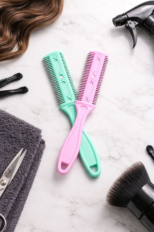 Hairbrushes, towel, scissors, and hairdryer on a marble surface