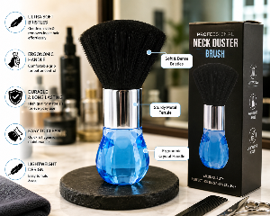 A neck duster hair brush with a blue faceted crystal handle, black bristles, and a silver metal ferrule, displayed next to its black retail box on a marble surface. The image includes feature callout graphics and text overlays describing the product's benefits.